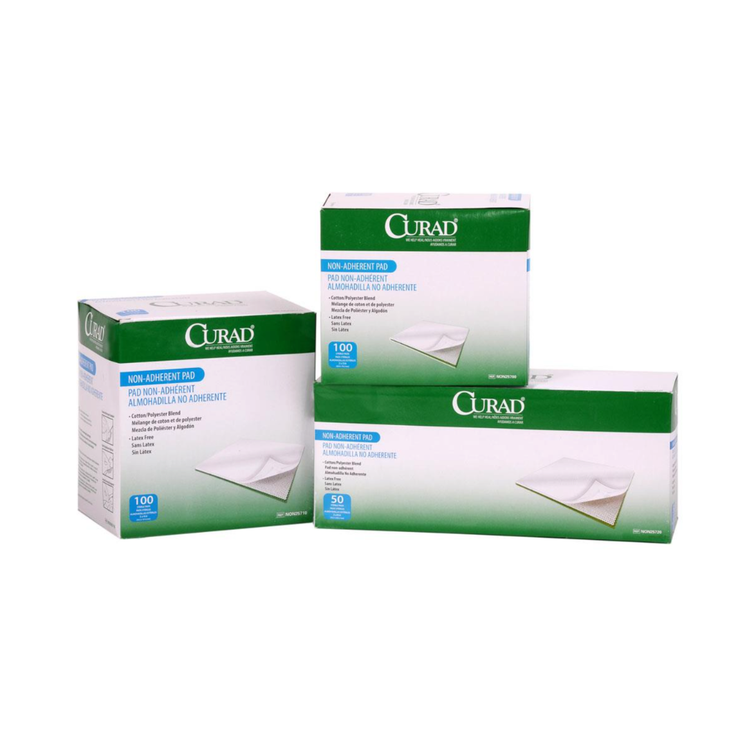 Three boxes of Medline CURAD Sterile Nonadherent Dressing Pads are shown—two large boxes with 100 pads each and a smaller one with 50. Green and white packaging highlights product images and clear labeling.